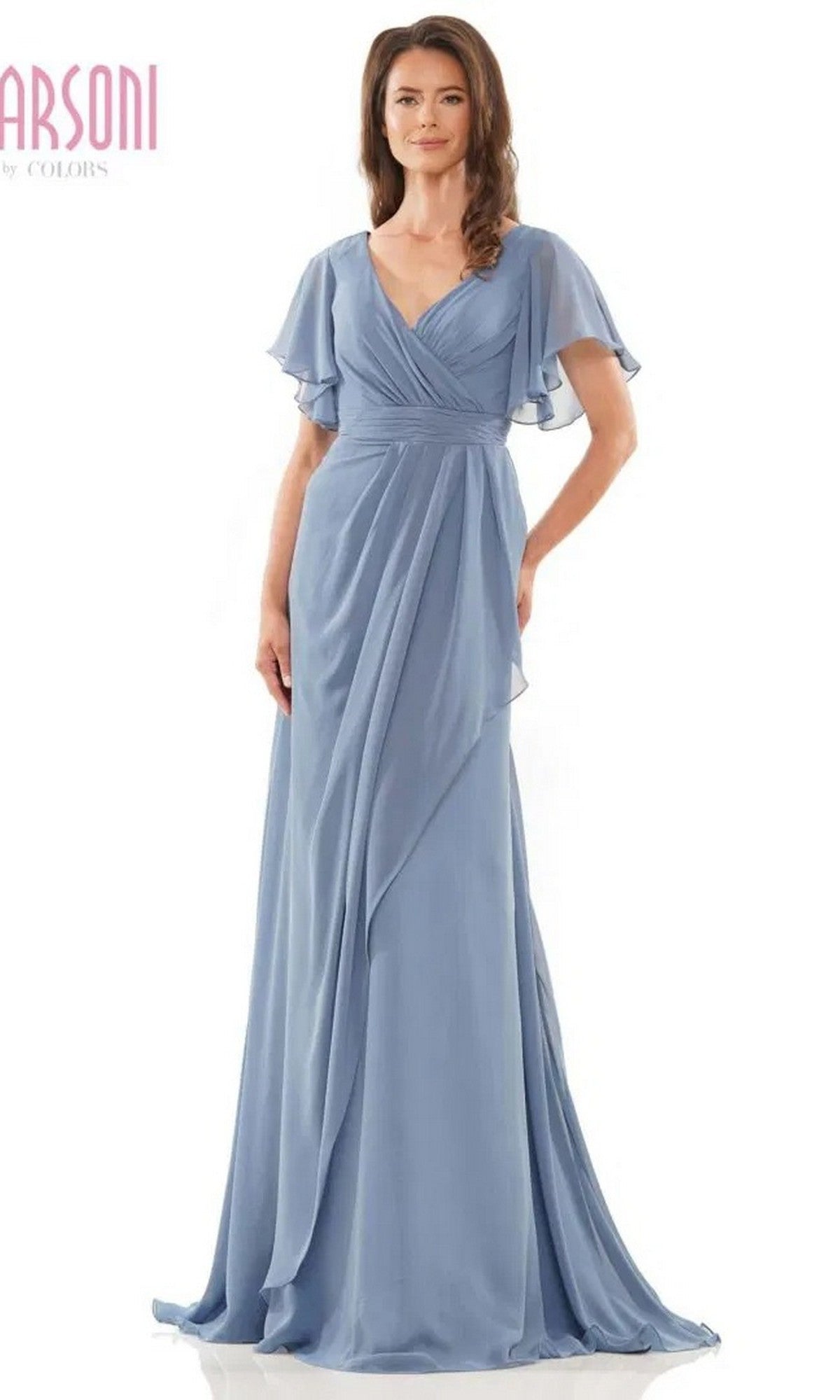 A woman wears the Marsoni M320 Long Formal Dress in slate blue, a floor-length chiffon gown with short flutter sleeves, a V-neckline, and an elegant A-line skirt.